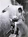 TN_HowardCarterCrouchesBeforeGildedShrineOfKingTut.jpg